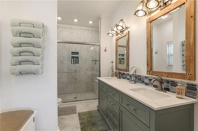 This is the primary bathroom showing the double vanity and shower area.