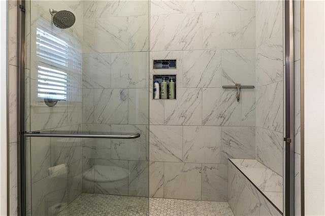 This is the shower with a sitting area inside.