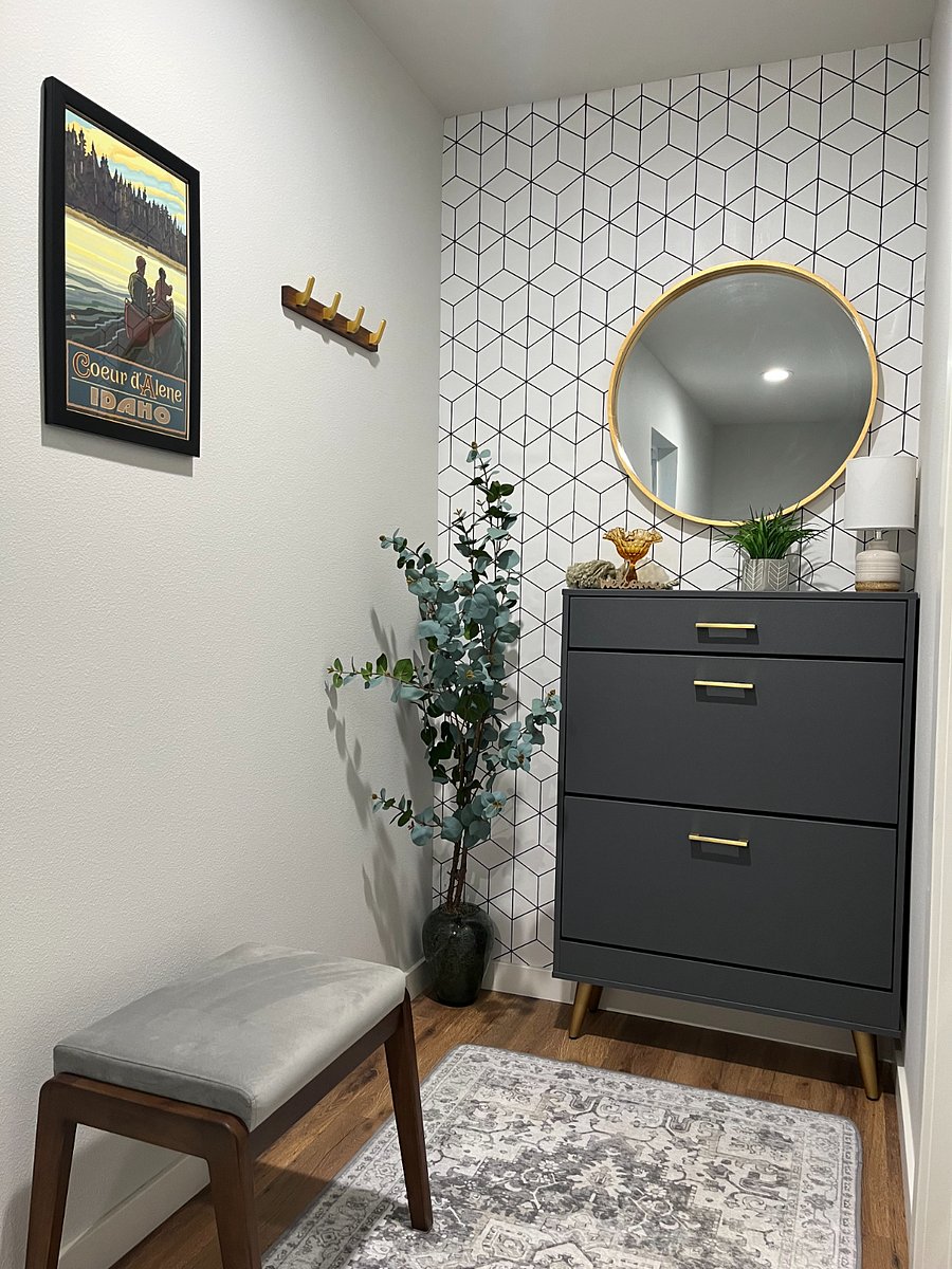 Entry hall at the top of the stairs; coat hooks, shoe dresser and bench for shoe removal.