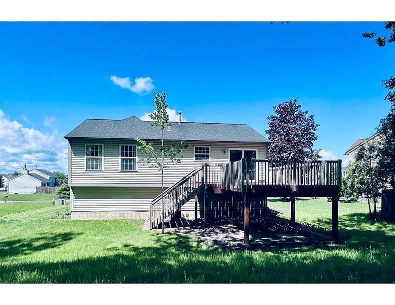 Nice quiet yard that backs up to a wooded area with a fire-pit with picnic table. New Fence is not in these photos. White Vinyl with ornamental aluminum dog fence across the back.