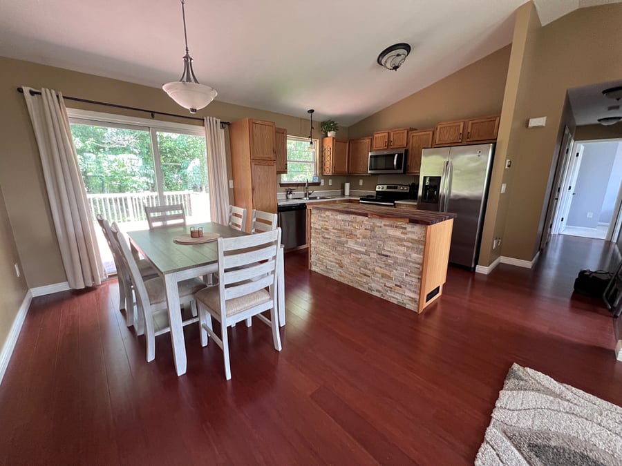 Slider leads to a large deck overlooking a beautiful private wooded lot.