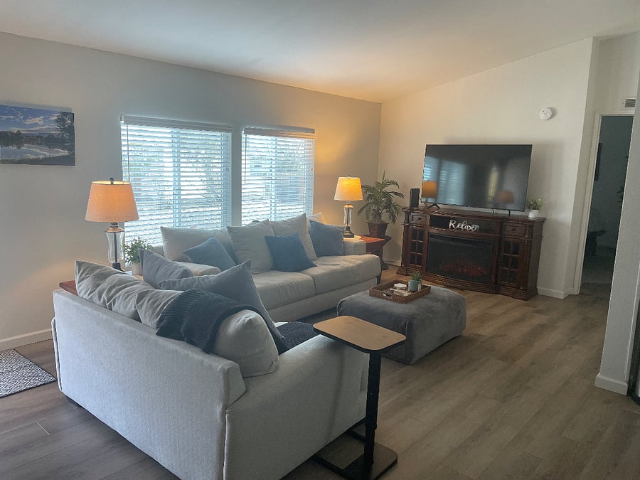 Living room with large smart tv and electric fireplace