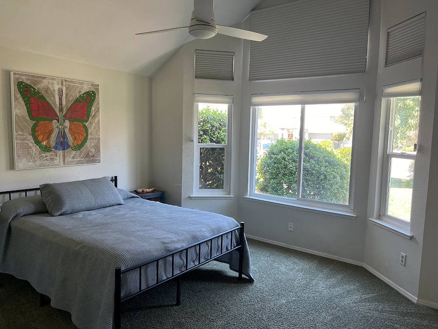Larger bedroom, queen sized bed, closet with built in shelves