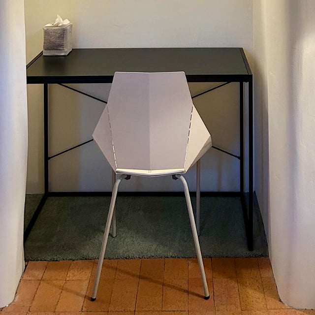 Writing desk with dedicated light and storage above.