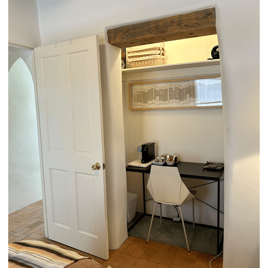 Writing desk alcove with Breville Nespresso espresso machine. Storage shelf above.Coffee amenity