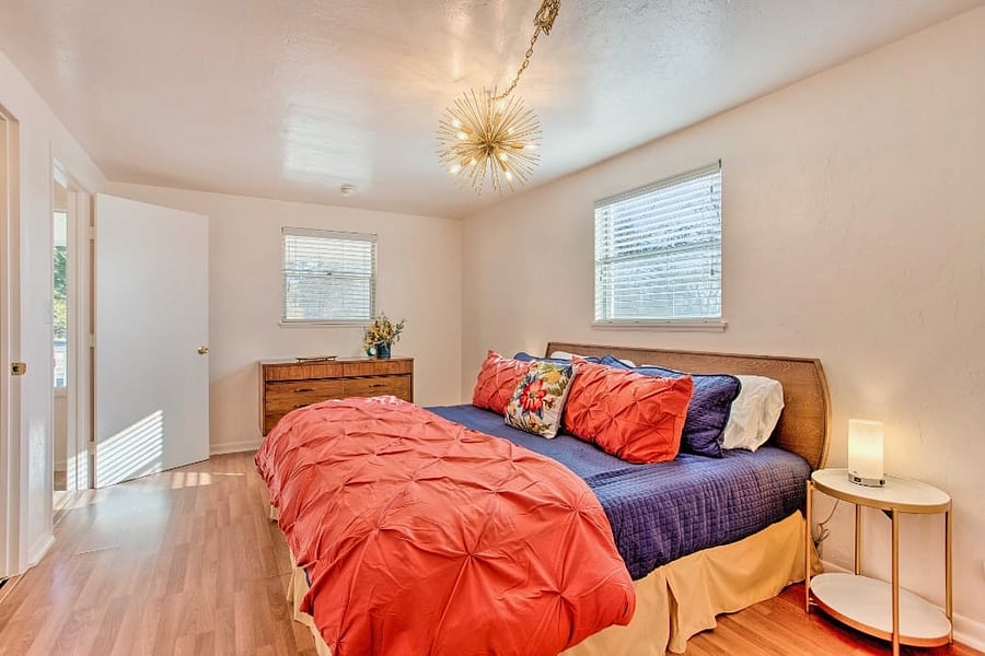 Unwind in the master bedroom at Whitewood Farm, featuring a plush king bed, ensuite bathroom, and built-in closet space.