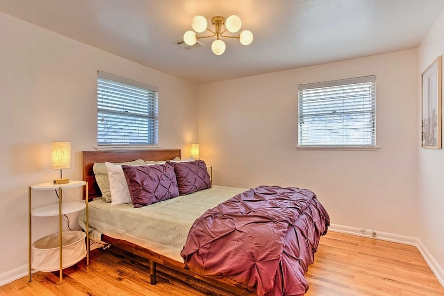 Bask in the serenity of Whitewood Farm's queen bedroom, featuring a closet and an abundance of natural light for a bright and welcoming atmosphere.