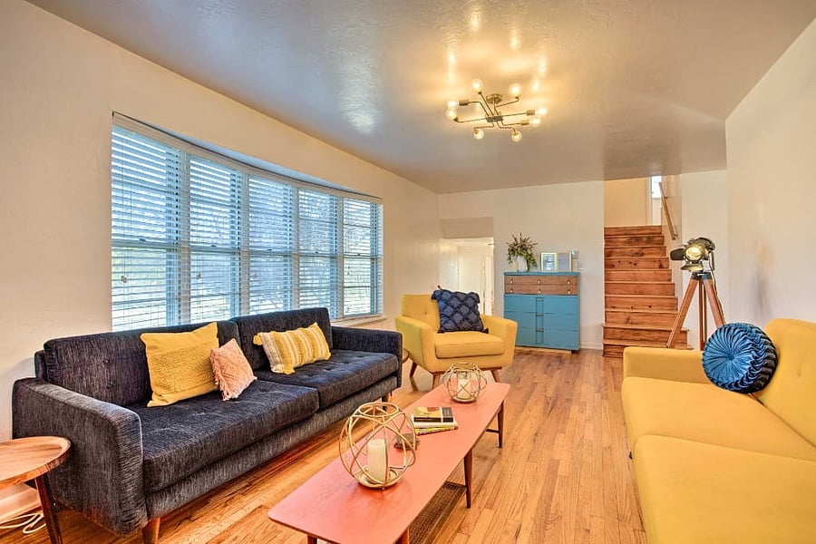 Relax in the stylish mid-century modern living room at Whitewood Farm, featuring a ROKU smart TV, DVD player, and a curated collection of classic DVDs for your viewing pleasure.