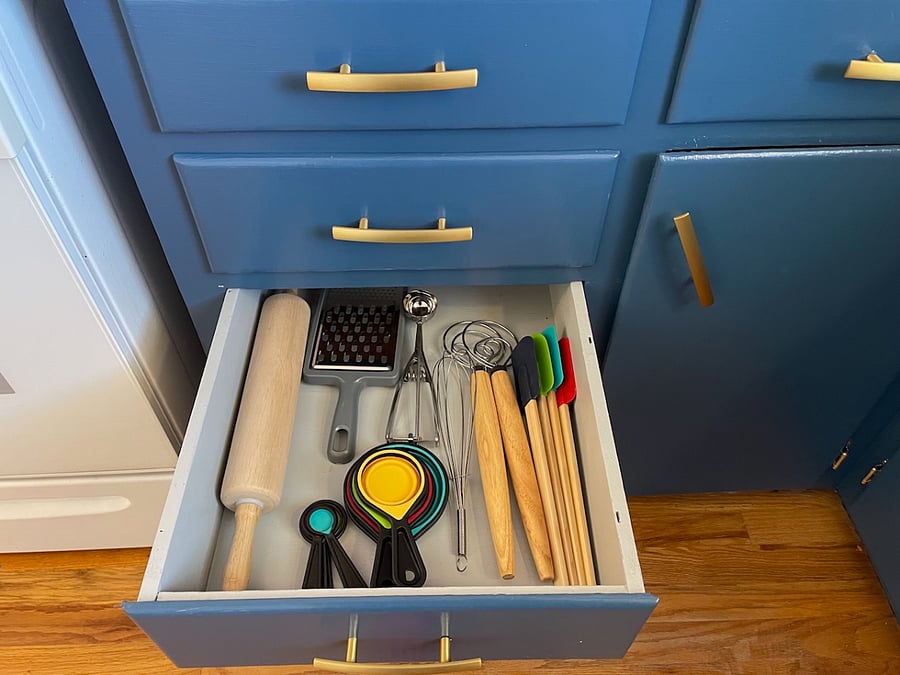 In the lower cabinet section of the south side of the kitchen you'll find an array of cooking and serving utensils, designed to make cooking and serving food a breeze.