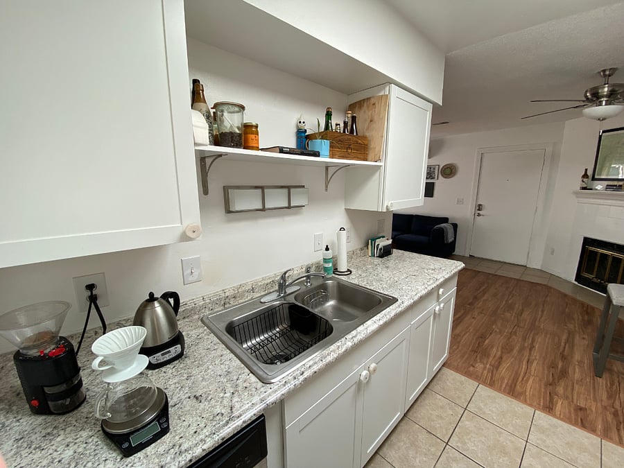 Full stocked kitchen with coffee kettle, garbage disposal, dishwasher, and dual sinks