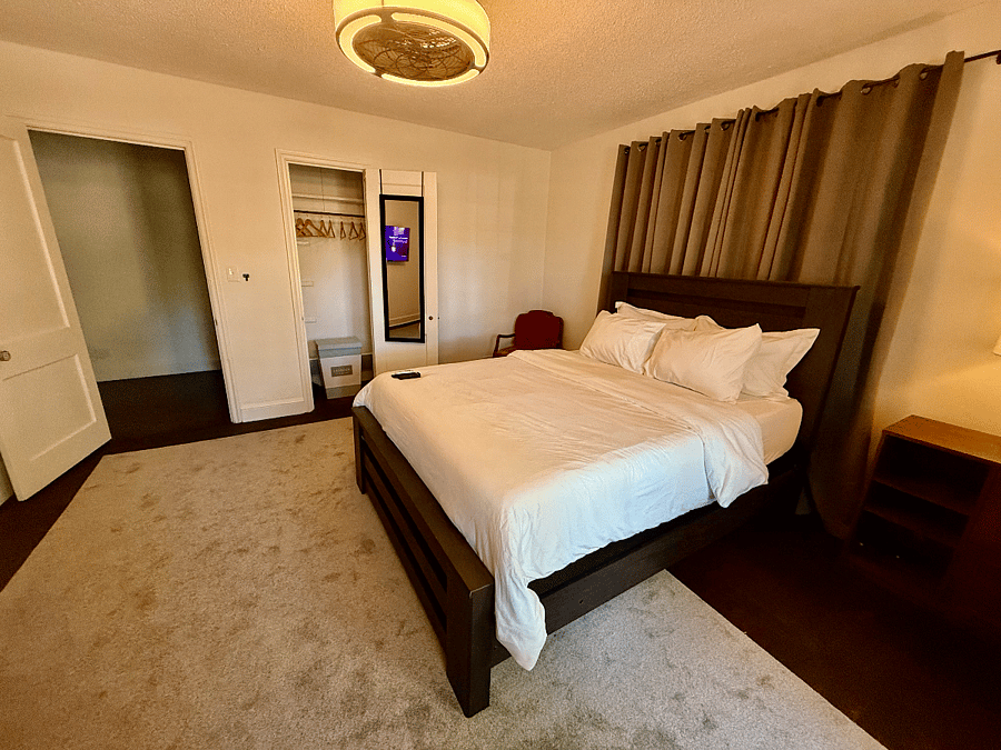 This cozy second bedroom includes a closet for convenient storage and a television for relaxing downtime. It offers the comfort and privacy of a hotel stay at a fraction of the cost, with the added benefit of feeling truly at home. Unlike a hotel, you can leave your belongings behind, settle in comfortably, and enjoy the ease of returning to the same peaceful space each daymaking it ideal for extended stays.