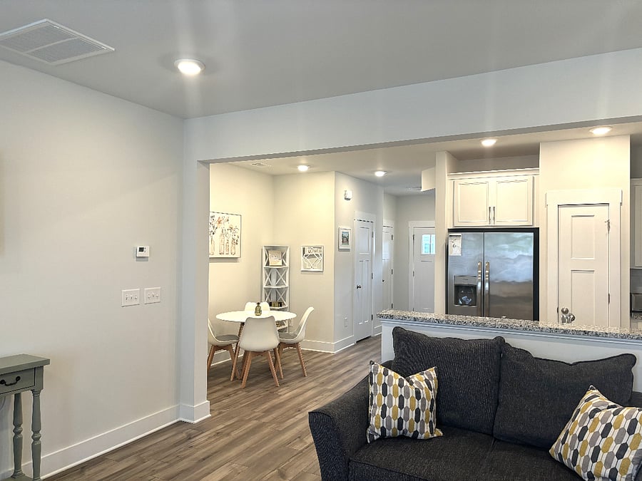 This view from the back of the townhouse shows the dinette and kitchen.  Everything is open and the space is well lit. 