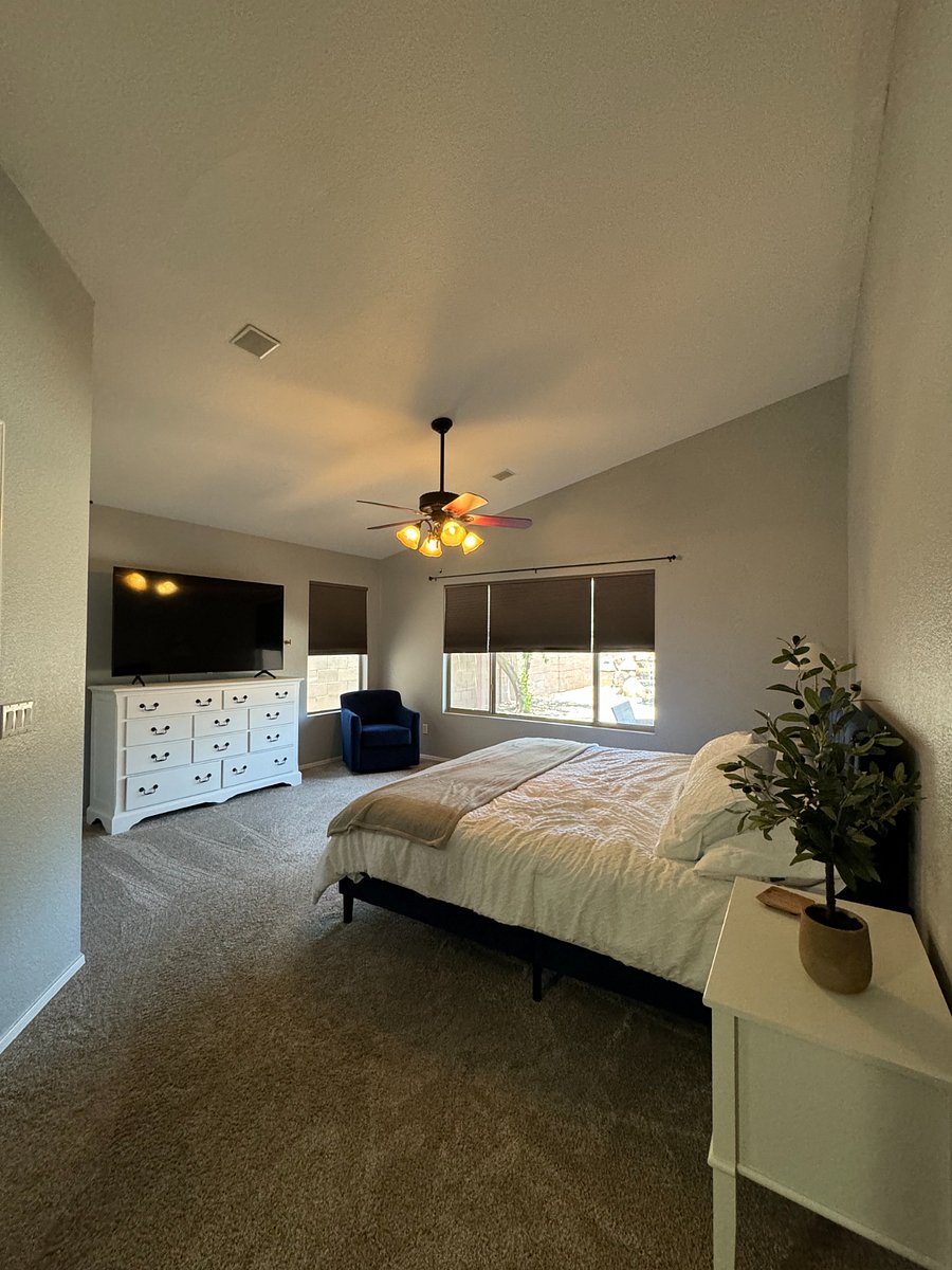 Primary Bedroom with king size bed and 65-inch Smart TV