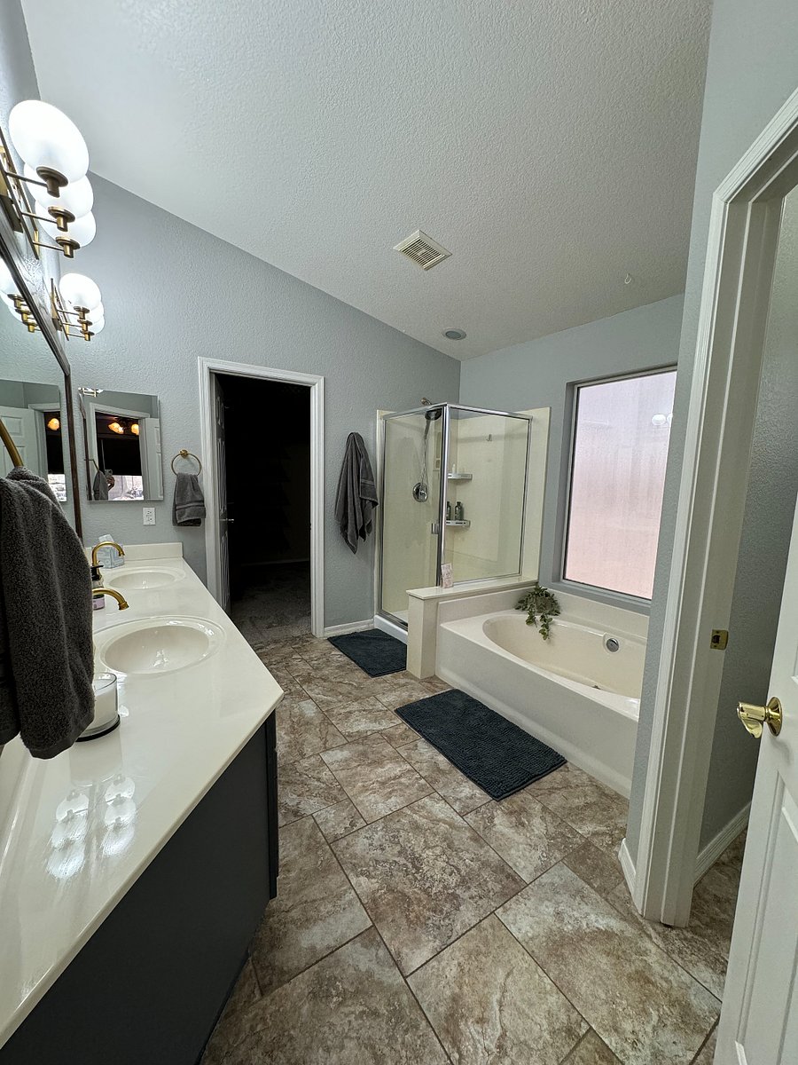 Primary bathroom with double sink, walk in shower and bath tub.