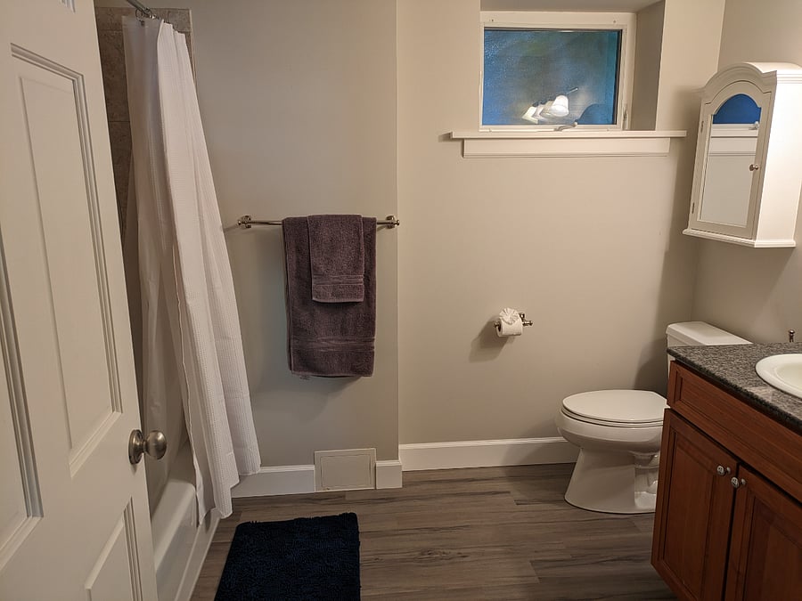 Full bathroom with entry to hall and entry into bedroom