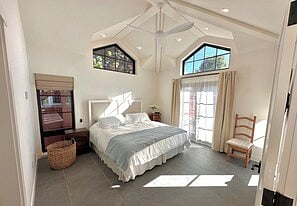 Master bedroom with French doors opening to a small patio.