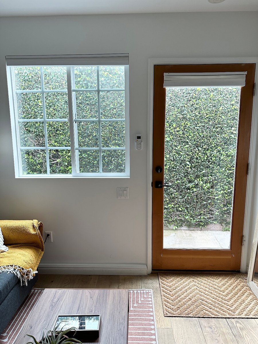 Window shades open to view green, private walkway, or closed for more privacy.