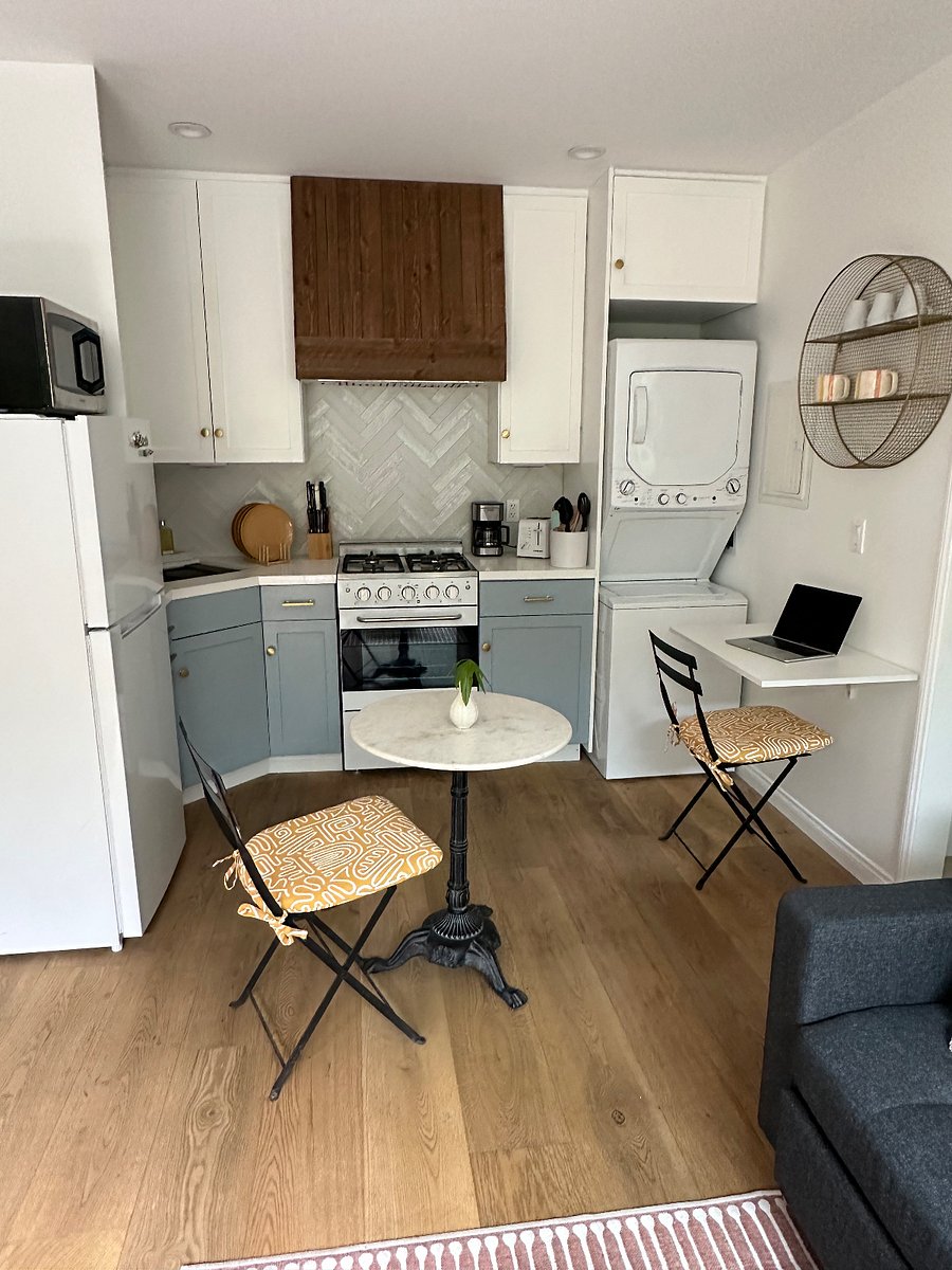 kitchen with stacked washer/dryer and gas range/oven
