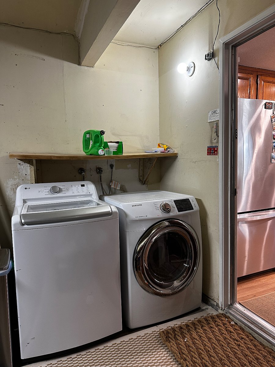 Laundry area located off kitchen within the garage