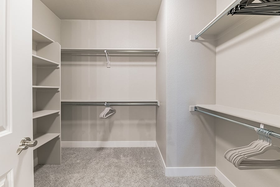 Primary suite closet: includes wood and velvet hangers, baby accessories and a full-length mirror.