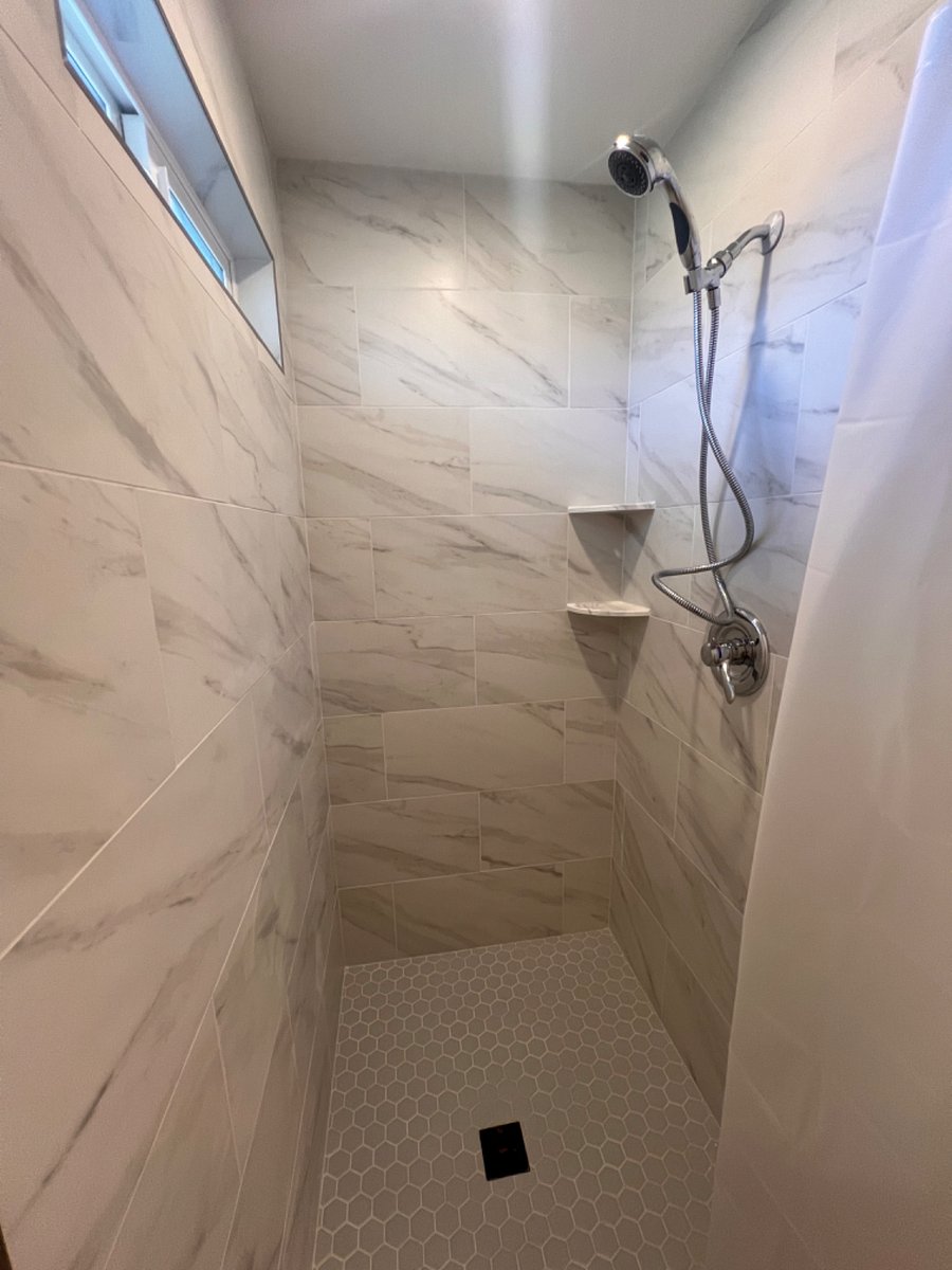 Shower is large and a window offers light and ventilation.