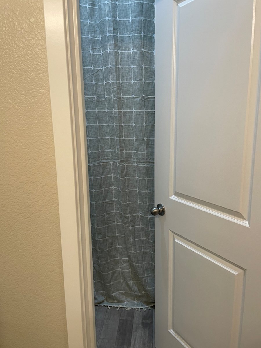 Spare bathroom door that leads to private toilet and shower