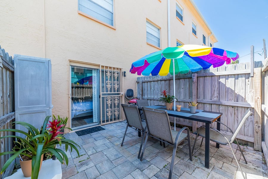 Outdoor private patio with grill.  Next to it open patio with garden. Iron Gate insures safety.