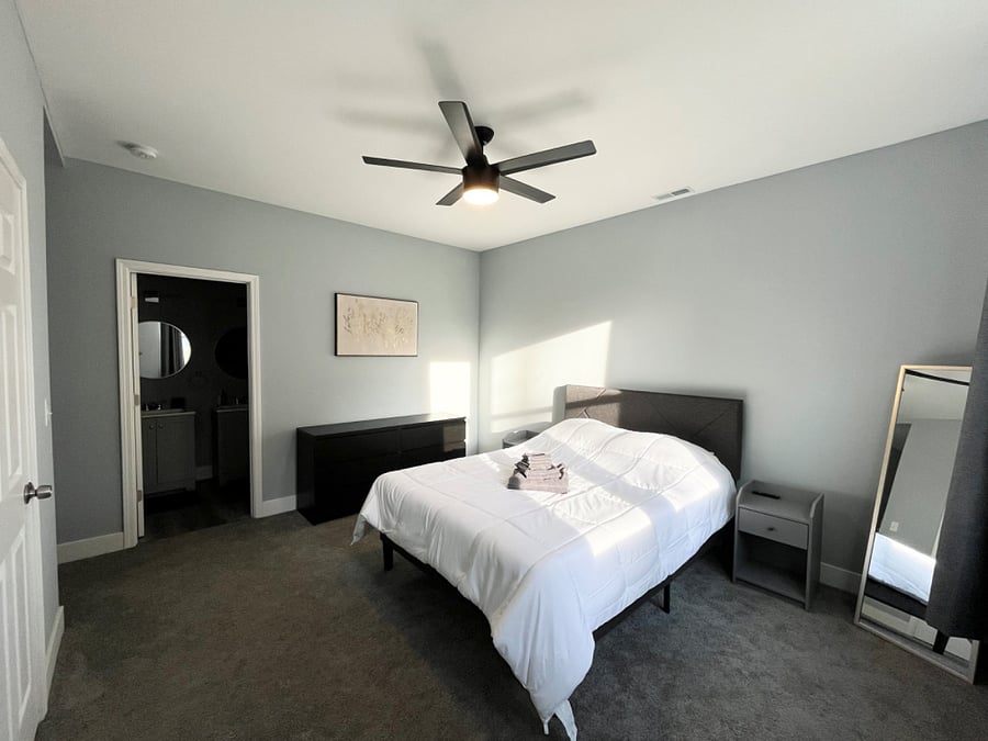 Master bedroom with full bath, walk-in closet, and TV