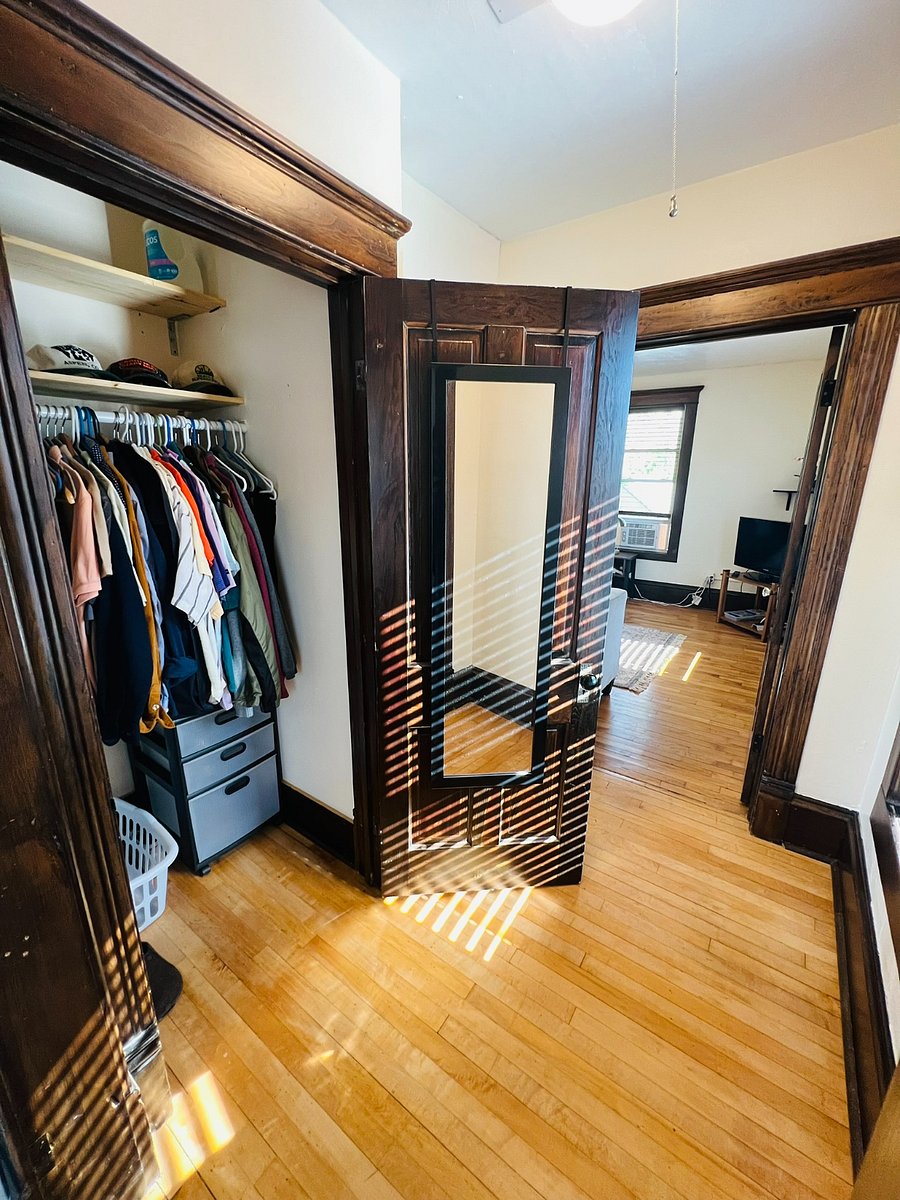 Closet with drawers, hanging shoe storage, and laundry basket