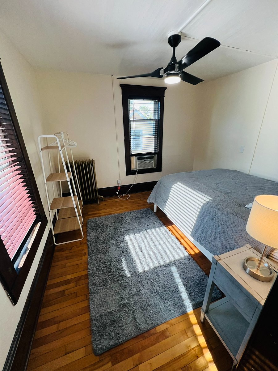 Bedroom include nightstand, lamp, and freestanding closet storage