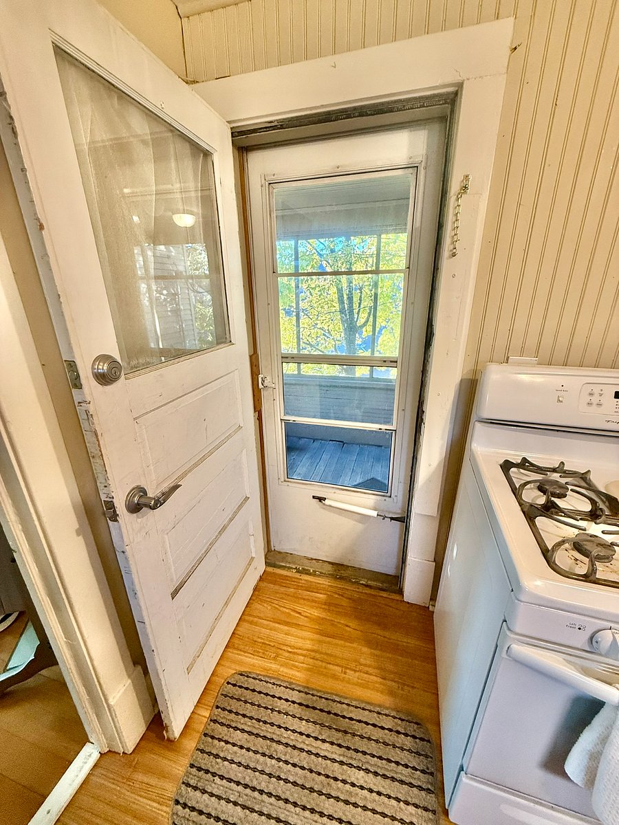 Kitchen door accesses screen porch and exterior entrance.
