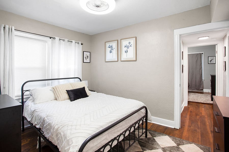 The first bedroom has one queen bed, dresser, and small closet. 
