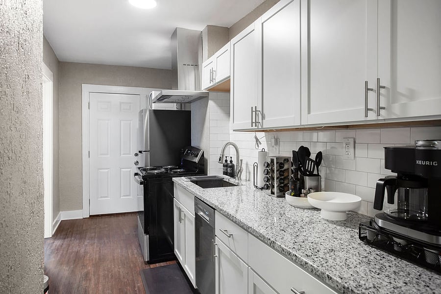 The galley kitchen has brand new appliances, granite counter tops, and stainless steel appliances. 