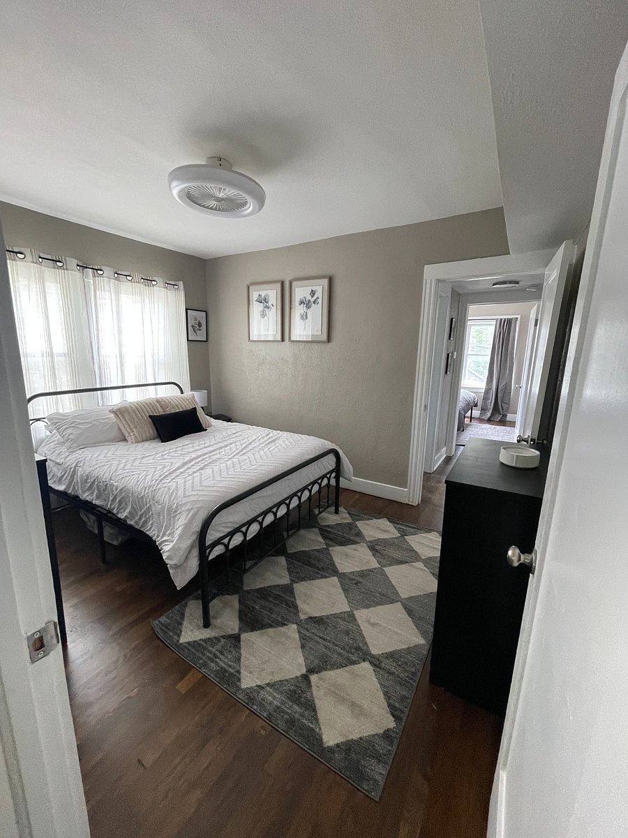 The first bedroom features a queen bed and dresser with a closet.