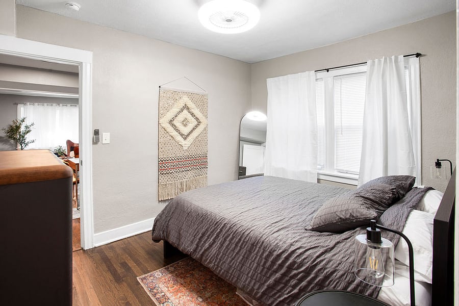 The first bedroom offers a queen bed with a dresser and small closet.