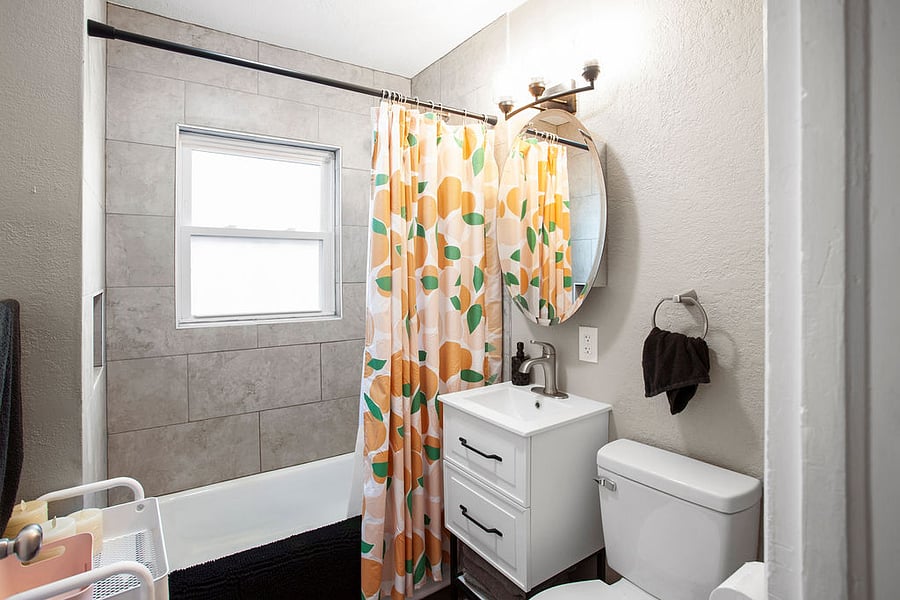 The newly updated tiled bathroom and bright lighting to get ready for the day. 