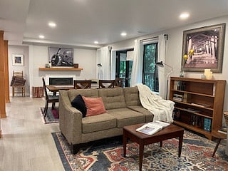 Living room area with view of dining and fireplace