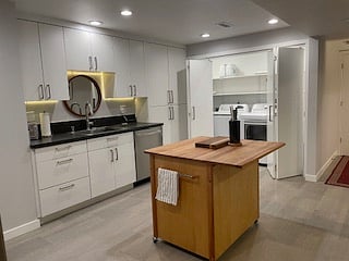High capacity washer, dryer, laundry sink and storage