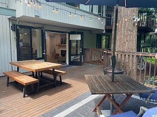 Exterior private deck, fenced with 2 gates. Picnic table, 2 benches, umbrella with table with 2 cushioned chairs and wood firepit