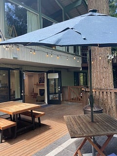 Exterior private deck, fenced with 2 gates. Wood firepit and festive lights for evening enjoyment