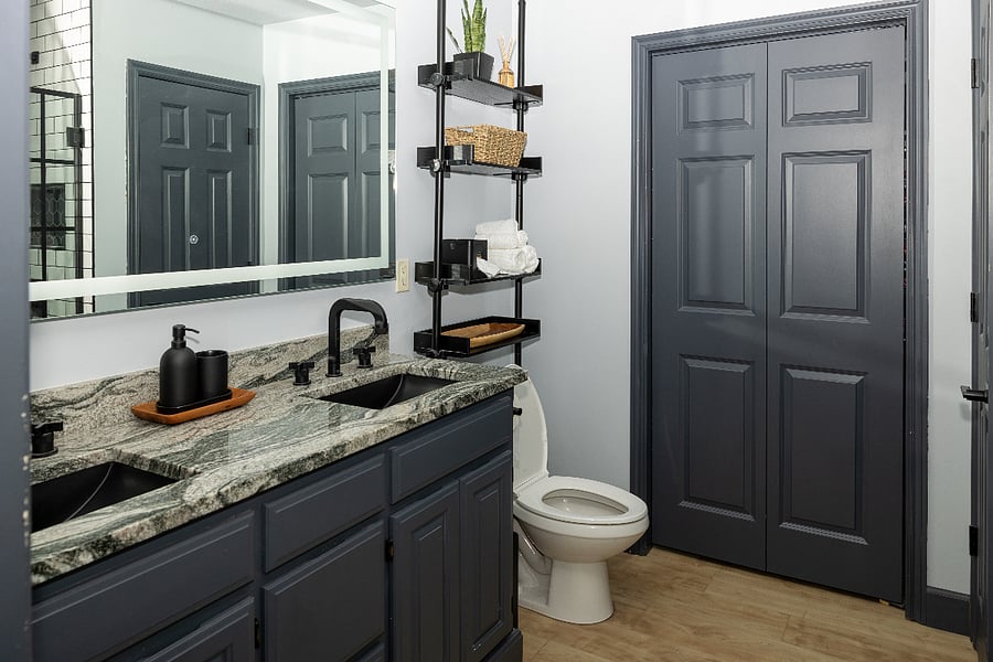 Master bathroom with double sink and large mirror with prime lighting.