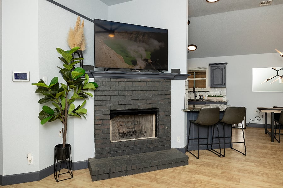 Living room with fireplace. Open concept from living room to kitchen.