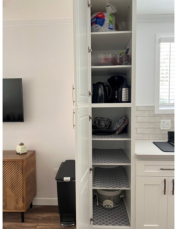 Pantry, Crockpot, Coffee maker, mixing bowls, measuring cups/spoons, electric kettle, fruit baskets, and pyrex