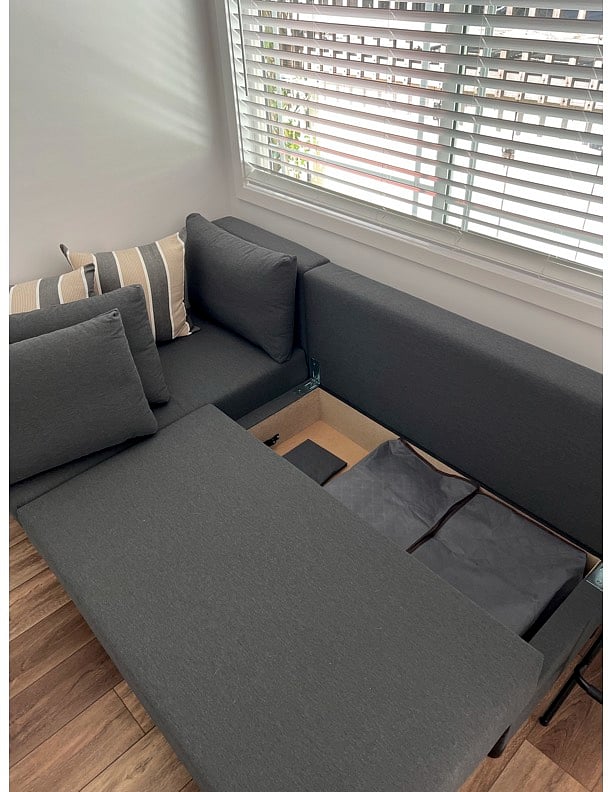 Storage Under couch w/ extra linens, towels, and pillow