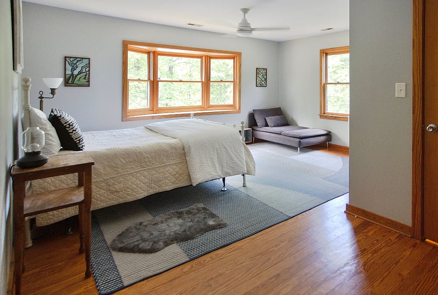 "Sunset" bedroom. Full size bed, lounge chair, desk, closet.