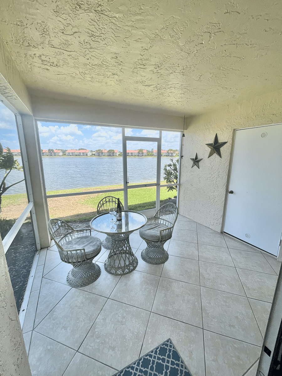 Lanai overlooking the lake, screened in porch with table & chairs