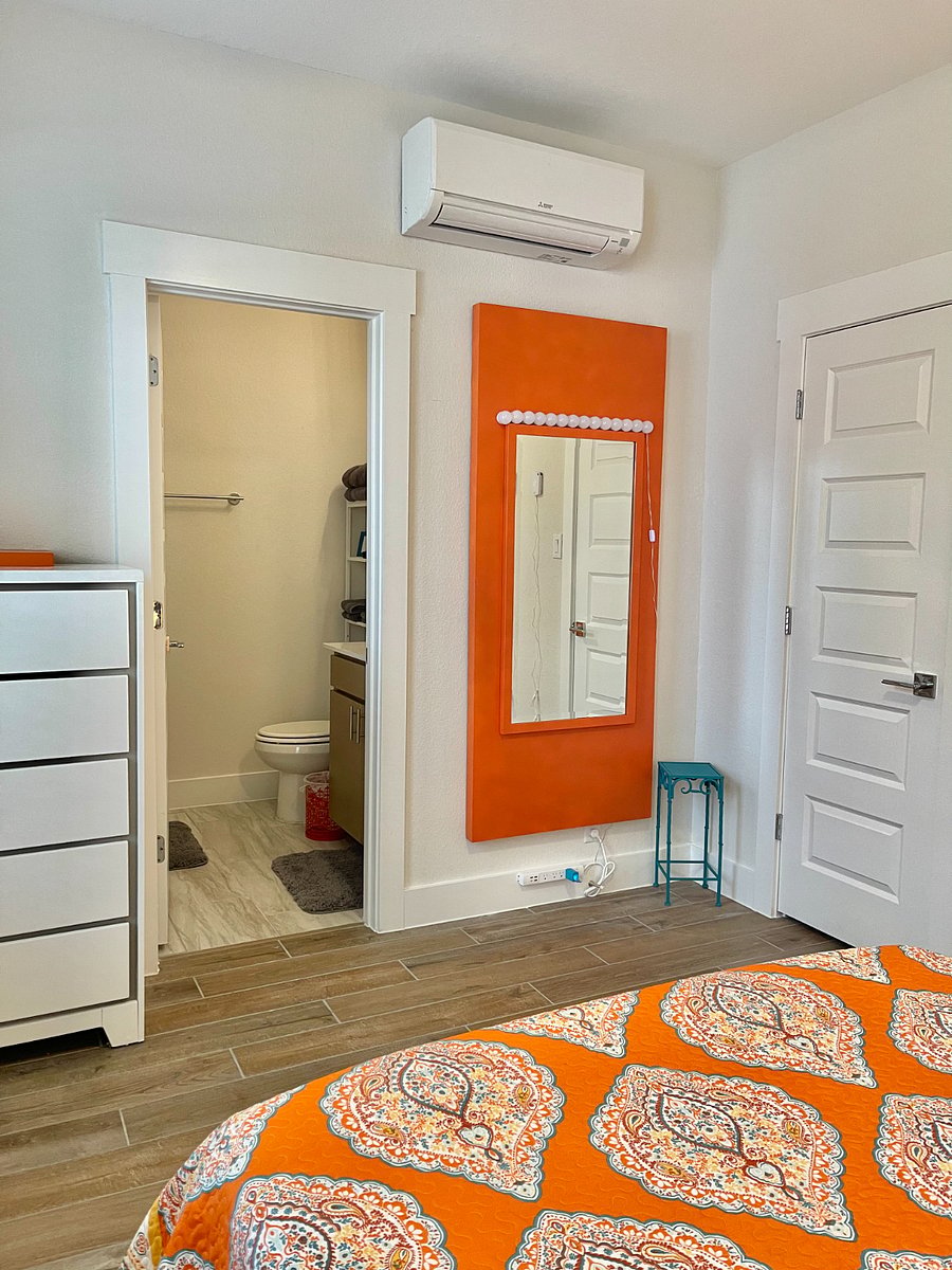 2nd bedroom has a large chest and full length wall mirror. Full bathroom within the bedroom.