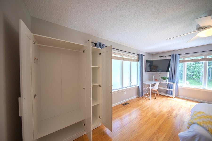 Bedroom 2 armoire and 55 inch smart TV