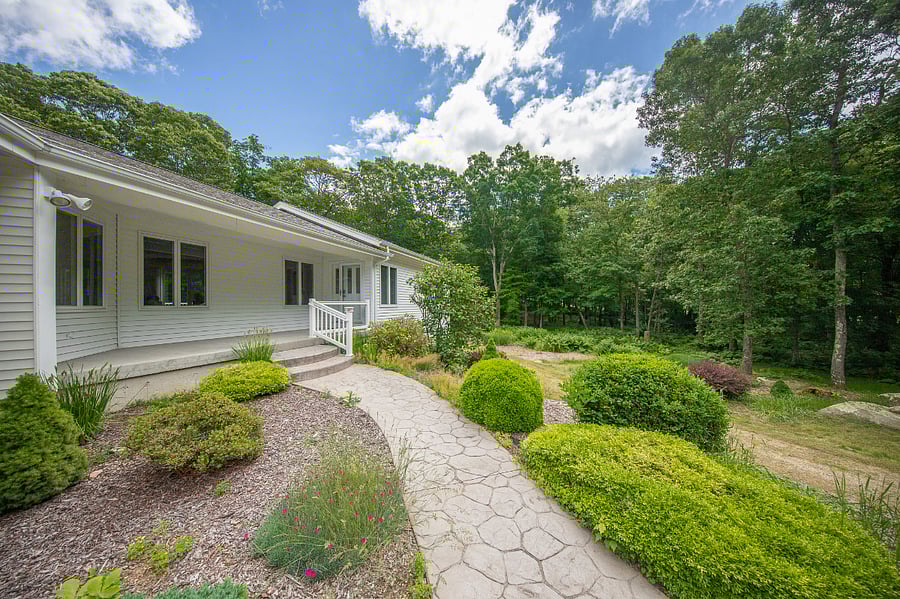 Private front entrance with flower beds. 