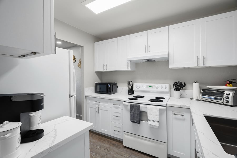 Kitchen with newly updated cabinets and countertops. Comes equipped with Keurig Coffee Maker, Toaster Oven, Microwave, general/kitchen utensils, plates/pots/pans